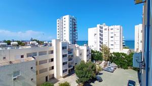 an aerial view of buildings in a city at 5 min to the Beach Holiday Shared Apartment - private ROOM in 3 bdr Apt in Larnaka