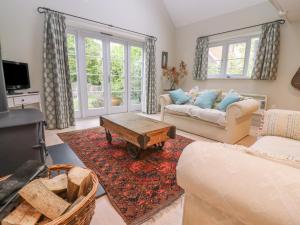 a living room with a couch and a coffee table at Bridge Studio in Broad Chalke