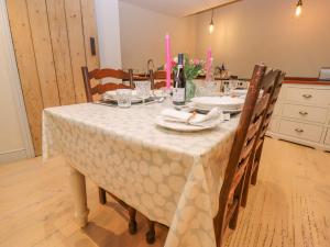 a dining room table with a white table cloth on it at Bridge Studio in Broad Chalke