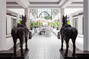 two statues of horses on display in a building at Anona Beachfront Phuket Resort-SHA EXTRA PLUS in Patong Beach