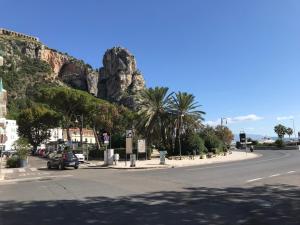 a street in front of a mountain with a road at B e B Riviera di Levante in Terracina