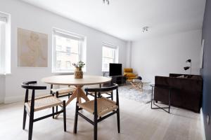 a living room with a table and chairs at 5VH Virginia House, 31 Bloomsbury Way in London