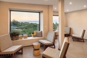a waiting room with chairs and a large window at Waterman Beach Village in Supetar