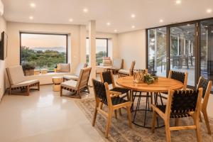 a dining room with a table and chairs at Waterman Beach Village in Supetar