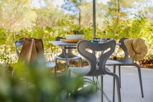 a table and chairs with a bowl of fruit on it at Waterman Beach Village in Supetar