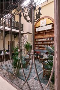 a lobby with a library with tables and chairs at Morando in Zamość