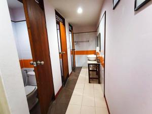 a hallway with a bathroom with a toilet and a sink at The Moon House in Chiang Mai +20 photos