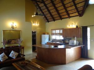 a kitchen with a large island in a room at Lituba Place in Marloth Park