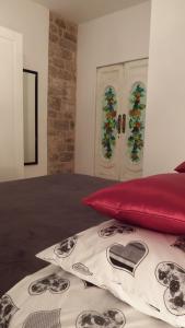 a bedroom with a red pillow and two christmas windows at Apartment Papalić Palace in Split