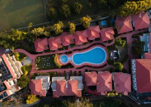 an overhead view of a resort with a swimming pool at Country Inn Tarika Riverside Resort Jim Corbett in Garjia