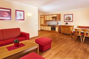 a living room with a red couch and a table at Apartment in Flachau with a terrace in Flachau