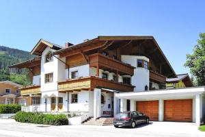 a house with a car parked in front of it at Apartment in Filzmoos with a balcony in Filzmoos