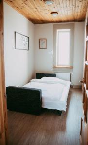 a bedroom with two beds and a window at RUMIDO Suite in Valmiera