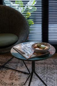 a bowl of food on a table next to a chair at Studios City Stay & Go Enschede in Enschede