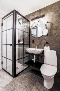 a bathroom with a toilet and a sink at Clarion Collection Hotel Cardinal in Växjö