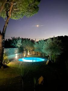 a large swimming pool in a yard at night at Villa REBECCA in Solanas