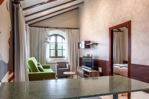 a living room with a table and a living room at Apartamentos Costa Esmeralda in Suances