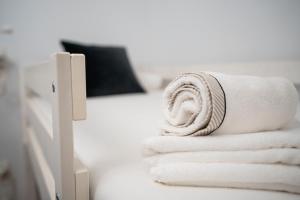 a stack of towels sitting on a counter in a room at HiHome Hostel in Oviedo