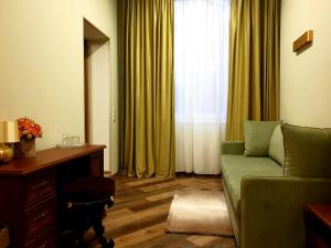 
a living room filled with furniture and a window at Kroshka Enot Hotel in Krasnogorsk
