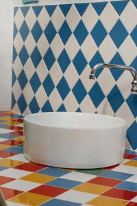 a bathroom with a white sink on a colorful floor at Sonho do Poeta in Sintra +40 photos
