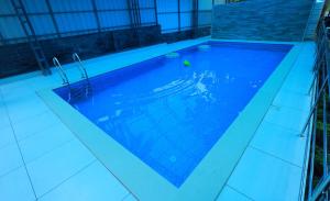 a swimming pool with a tennis ball in it at NARMADA HOMESTAY Ganga in Perintalmanna