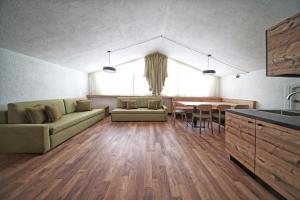 ein Wohnzimmer mit einem Sofa und einem Tisch in der Unterkunft TH La Thuile - Planibel Residence in La Thuile