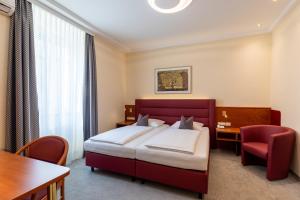 เตียงในห้องที่ Austria Classic Hotel Wien