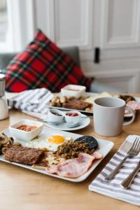 a table with a plate of breakfast food on it at Castle Park Guest House in Edinburgh