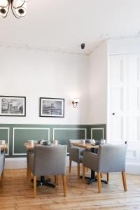 a dining room with a table and chairs at Castle Park Guest House in Edinburgh