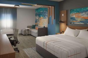a hotel room with a bed and a living room at La Quinta Inn & Suites by Wyndham Bardstown in Bardstown +33 photos
