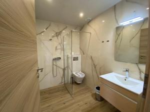 a bathroom with a shower and a sink and a toilet at Blue Sky in Frangokastello