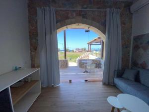 a living room with a large window and a couch at Blue Sky in Frangokastello