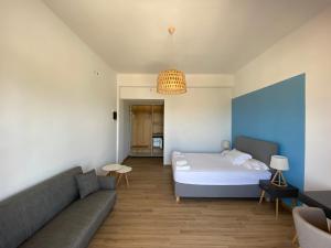 a living room with a bed and a couch at Blue Sky in Frangokastello