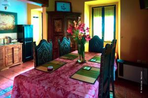 a dining room table with a vase of flowers on it at Lovely 4-Bed Cottage near Pedrogao Grande in Pedrógão Grande