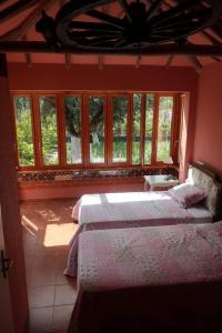 a bedroom with two beds and a window at Lovely 4-Bed Cottage near Pedrogao Grande in Pedrógão Grande