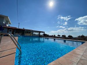 a large swimming pool with blue water at Blue Sky in Frangokastello