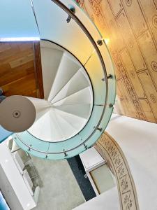 a spiral staircase with a glass and wooden ceiling at Rare 1-Bed Church Converted Apartment in London in London