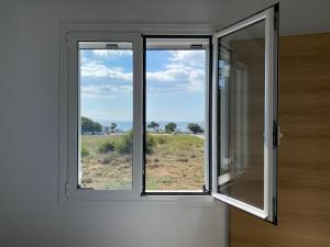 a window in a room with a view of a field at Blue Sky in Frangokastello