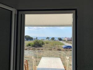 a window with a table and a view of a field at Blue Sky in Frangokastello