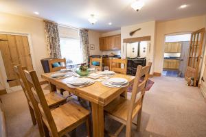 a kitchen and dining room with a wooden table and chairs at Lime Kiln Farm in Malton