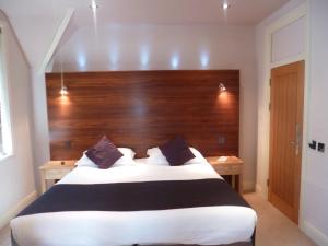 a hotel room with a bed and two nightstands at Castle Hotel in Aberystwyth