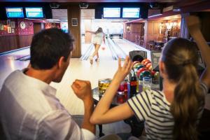 a group of people sitting at a bowling alley at Royal Hideaway Sancti Petri in Chiclana de la Frontera