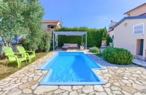 a swimming pool in the backyard of a house at Holiday house NIKA with pool and jacuzzi in Linardići