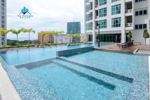 a swimming pool on the roof of a building at Straits Garden Suites by The Homestay Helper in George Town