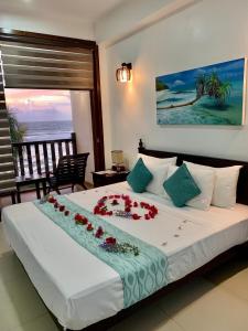 a bedroom with a large bed with flowers on it at The Pleasure Kosgoda in Bentota