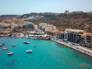 an aerial view of a harbor with boats in the water at Seafront Penthouse w unobstructed Sea Views in Mellieħa