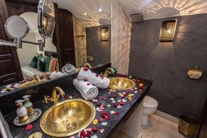 a bathroom with two sinks and towels on a counter at Dar Salam Palm - All Inclusive in Marrakesh