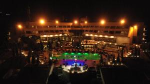 a building with a pool in front of it at night at Ashur Hotel in Dokan +49 photos