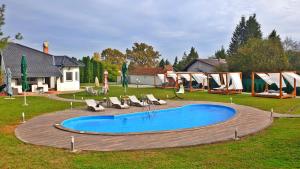 a swimming pool in a yard with chairs around it at Falamić Sport Resort in FeriÄanci