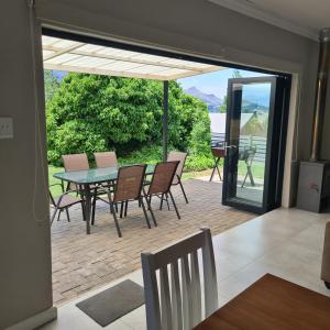 a dining room with a table and chairs on a patio at Clarens Escape (Unit 2) in Clarens